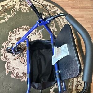 Walker in new condition has seat that flips up for storage department.